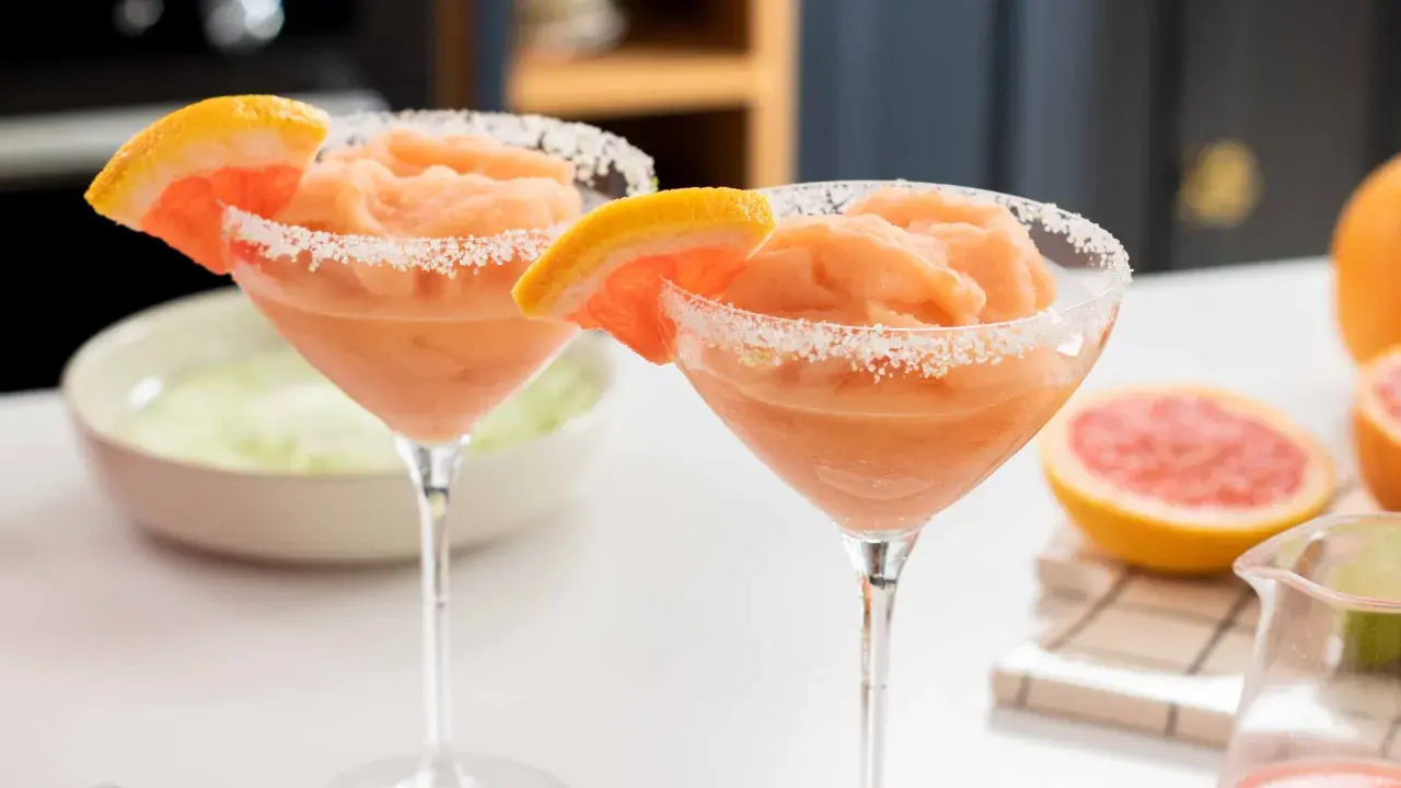 Deux cocktails givrés au pamplemousse, bordés de sucre, parfaits pour un cocktail pour 20 personnes original.