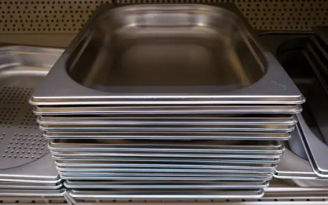 Pile de bacs gastro en inox, prêts à accueillir vos préparations culinaires.
